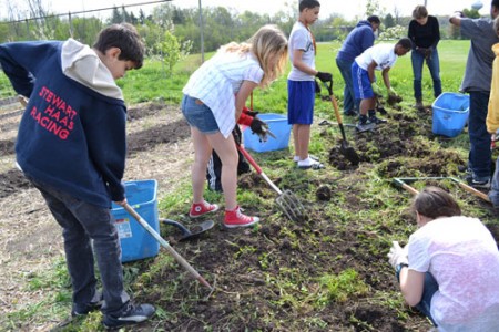 Susan Baker's life science class works in the garden April 20.