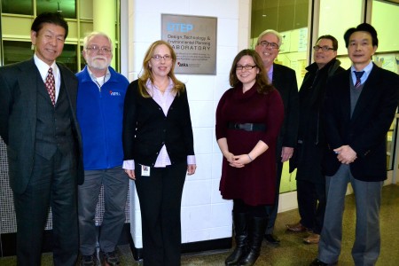 Left to right are IMRA staff Takashi Omitsu, president; Carl Leonard, engineer; Michele Schuler, CAD drafter; Dr. Kristin Cederquist, research scientist; Ken Castel, human resources manager; Brad Zieg, engineer; and Kazuo Ishikawa, assistant to the president. 