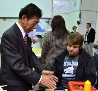 IMRA President Takashi Omitsu talks with student David Oginsky about the new equipment his company has funded.