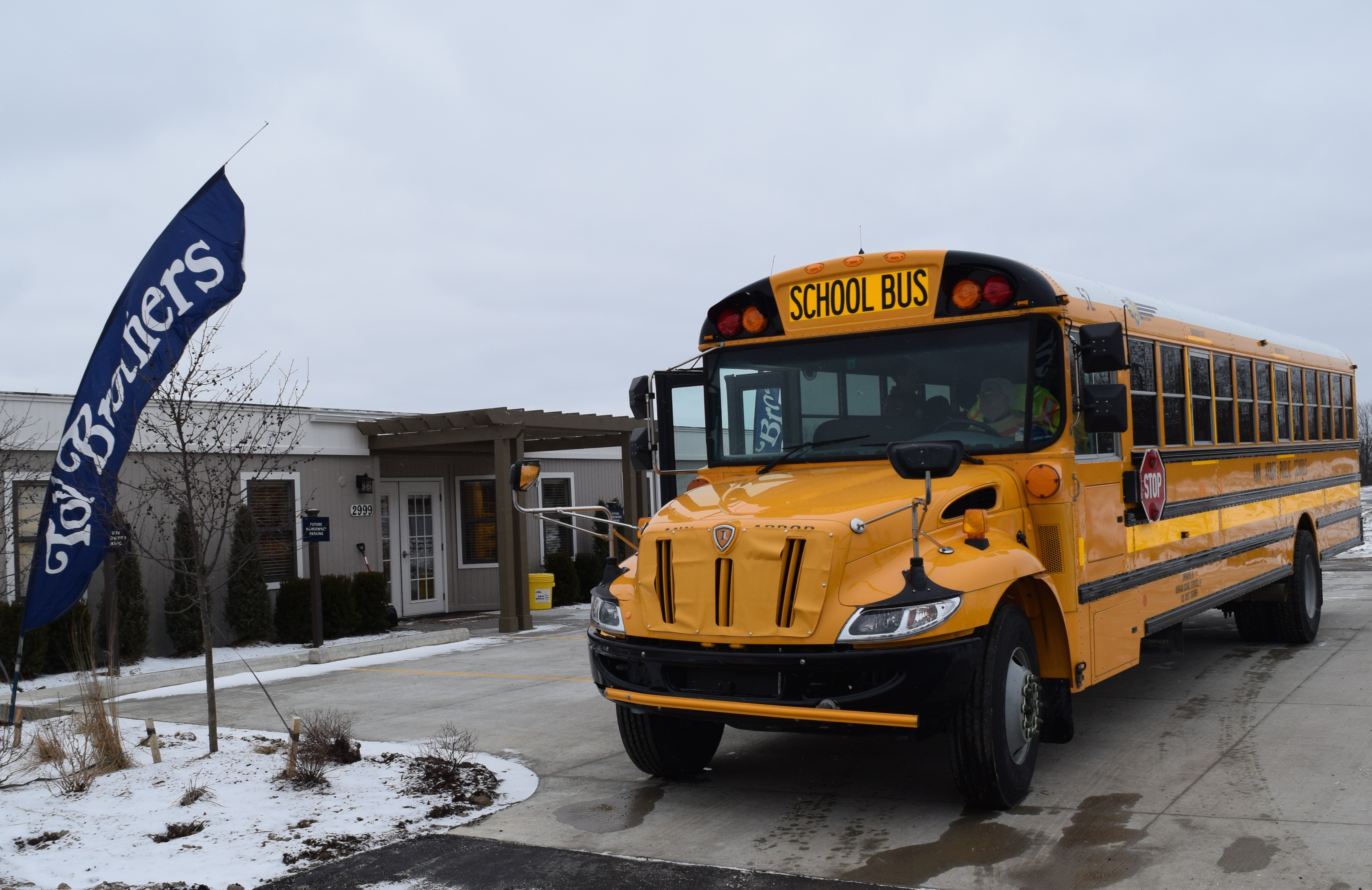 Ann Arbor Public Schools bus in front of Toll Brothers sales office for North Oaks development