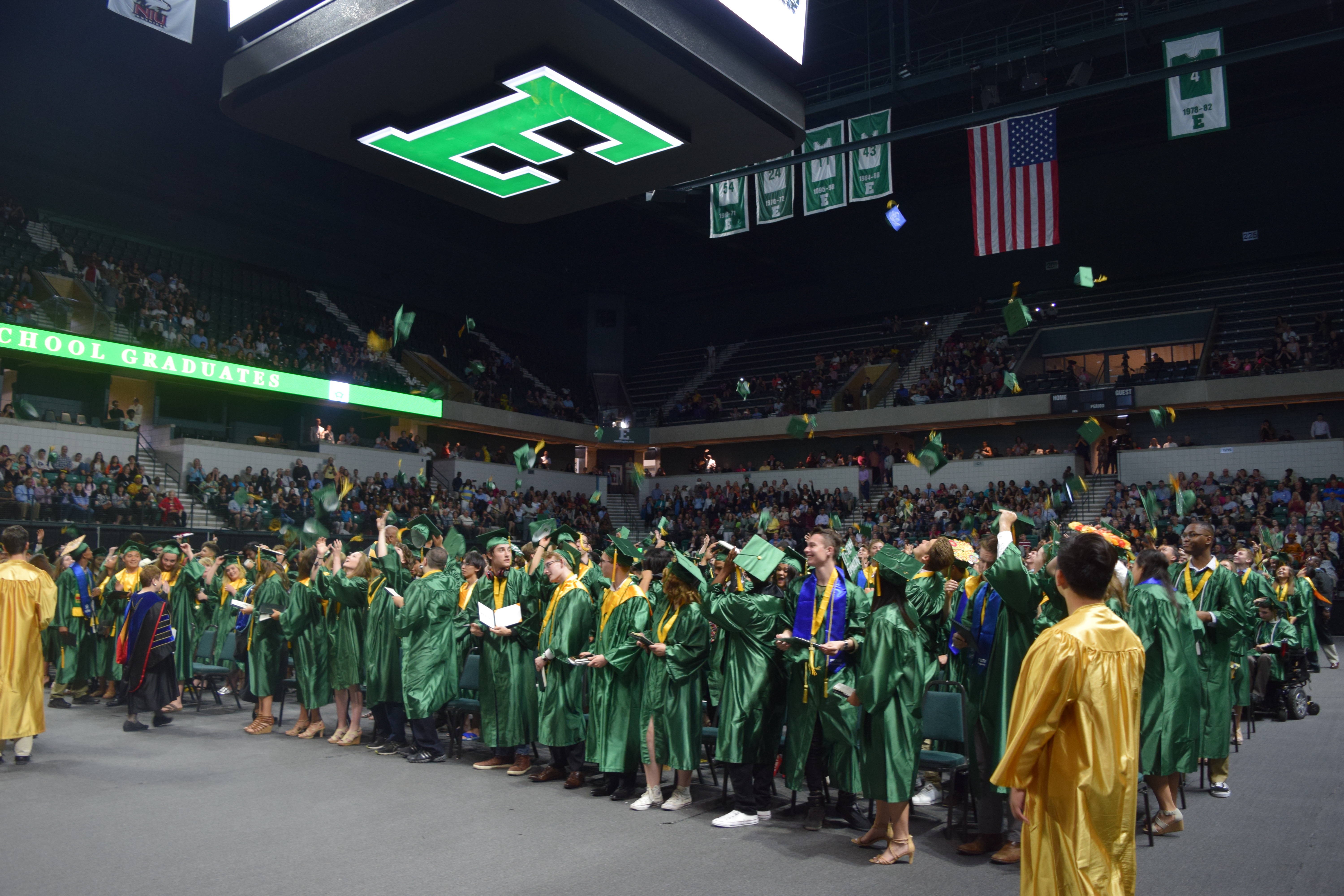 Members of the Huron High School Class of 2018 toss the caps into the air as they celebrate graduation