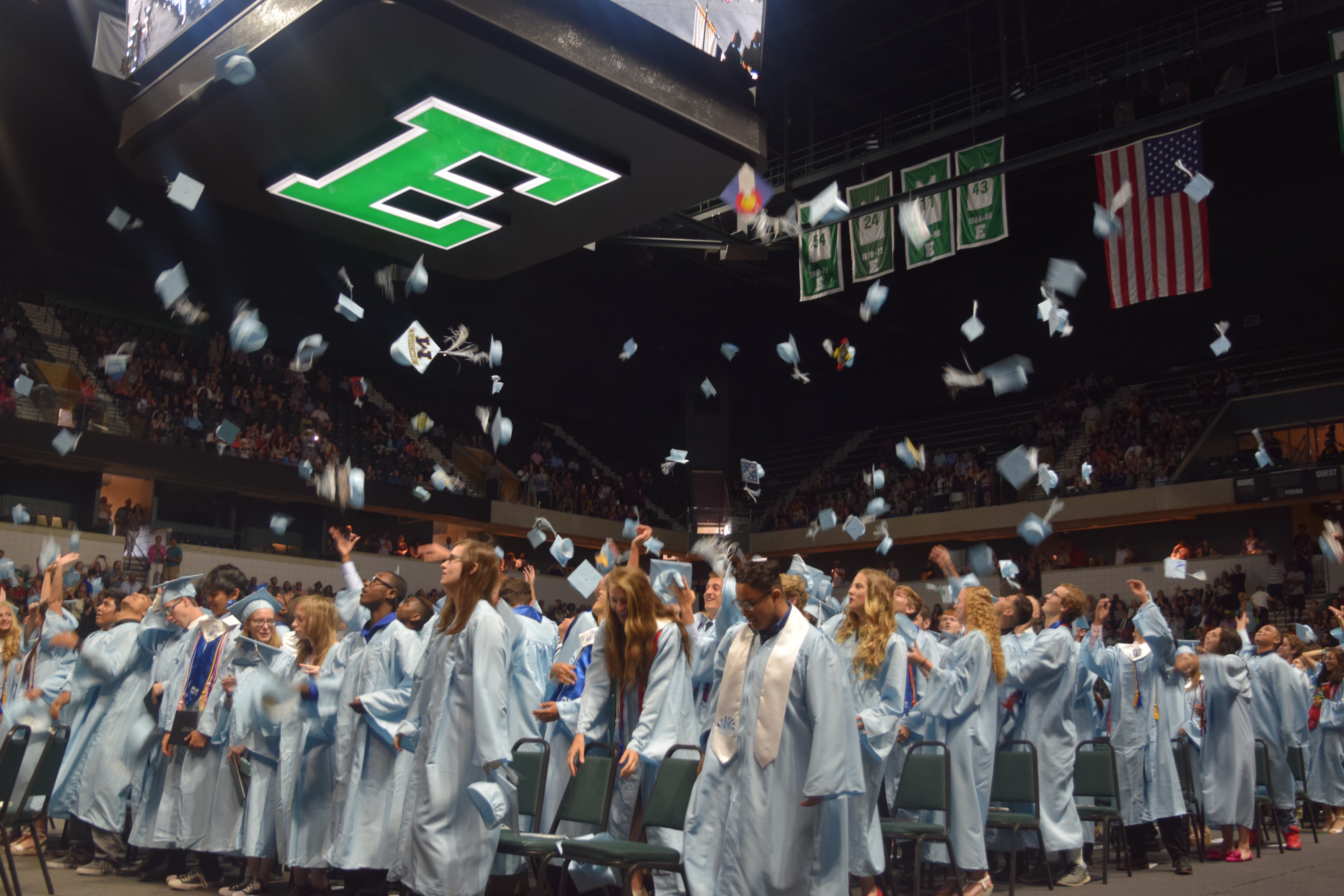 Skyline Graduates celebrate by throwing their caps up into the air