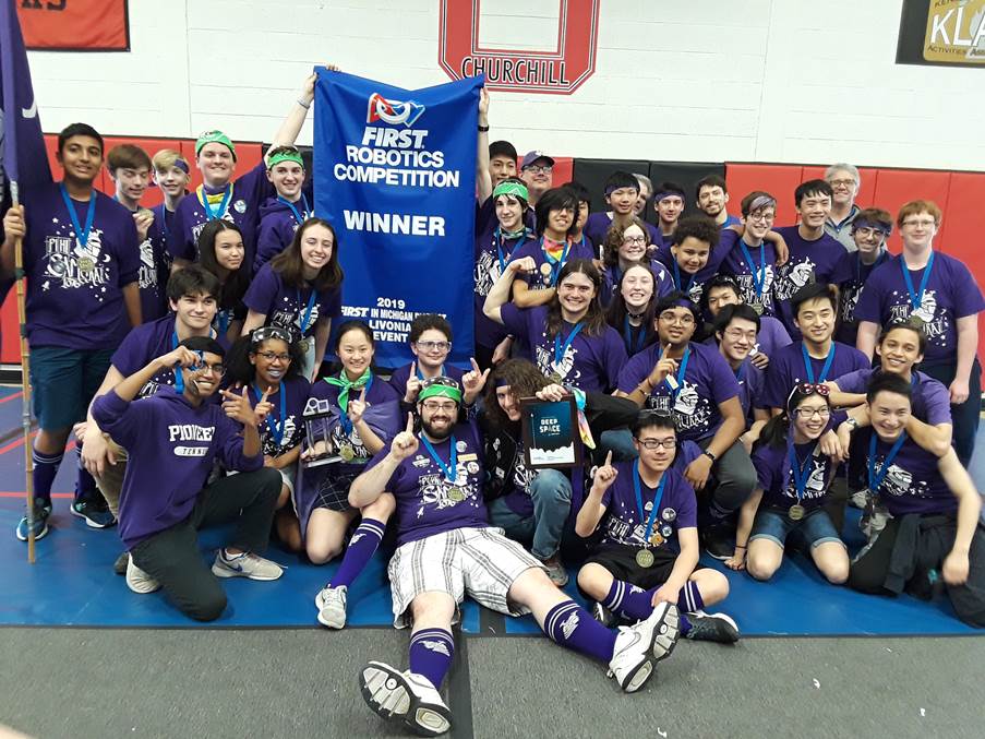 PiHi Samurai, Pioneer High School's robotics team celebrate with their championship banner