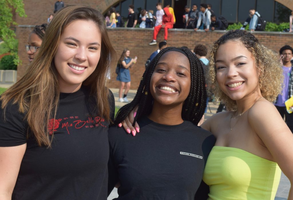 Three female students celebrate the last day of school at Huron High School before graduation