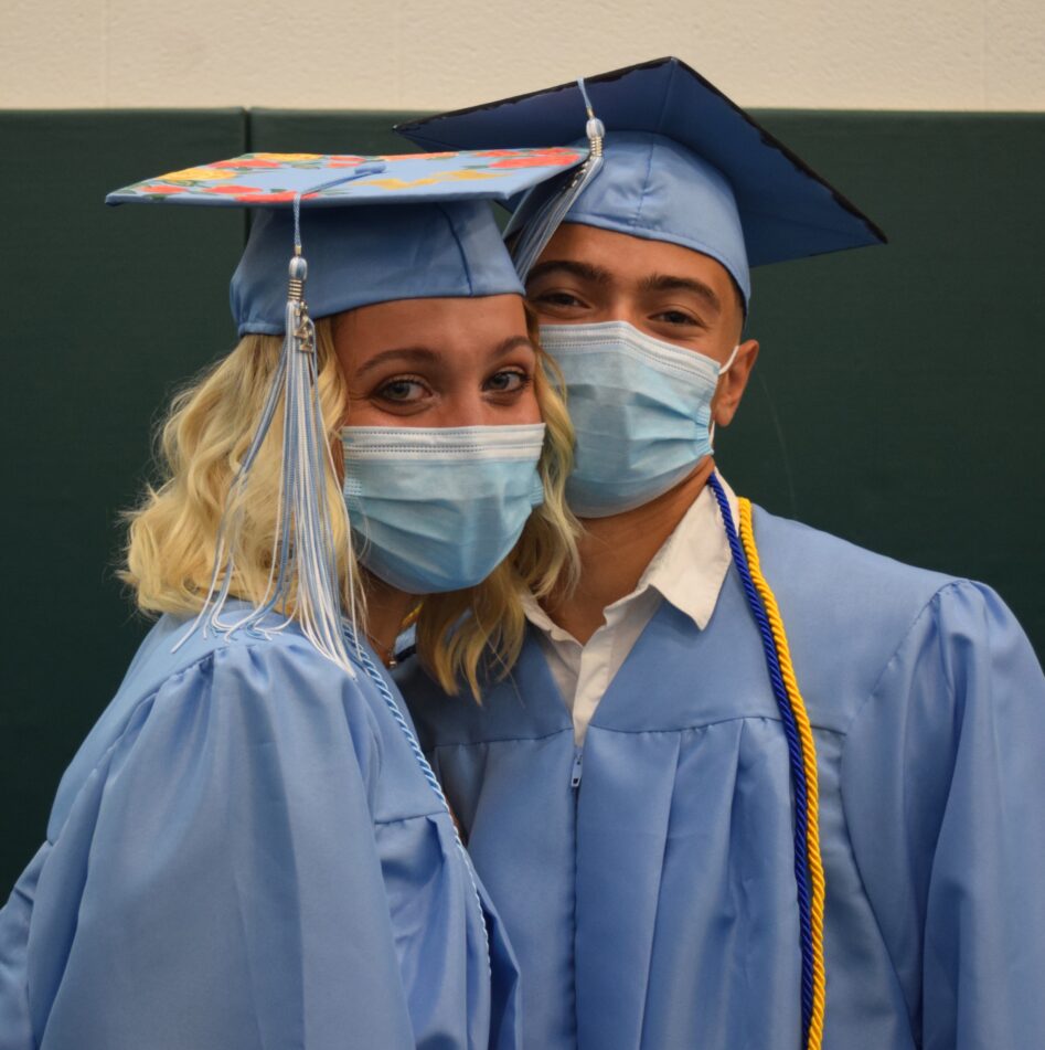 A female and male Skyline grad in caps and gowns