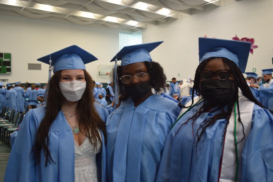 Three female Skyline grads before the ceremony in their caps and gowns