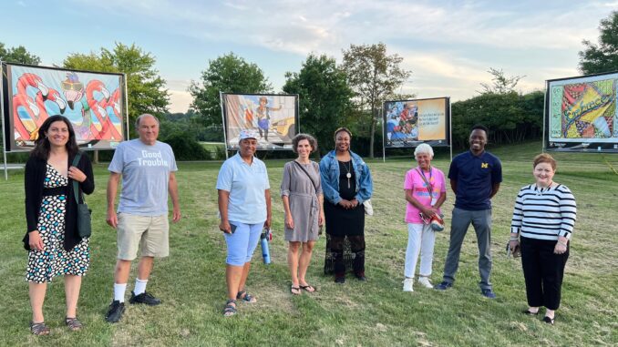 Members of the AAPS Board of Education, Superintendent Swift, Strategic Partnerships and Volunteer Coordinator Nancy Shore and Embracing Our Differences SE Michigan Executive Director Nancy Margolis at the art exhibit in Gallup Park