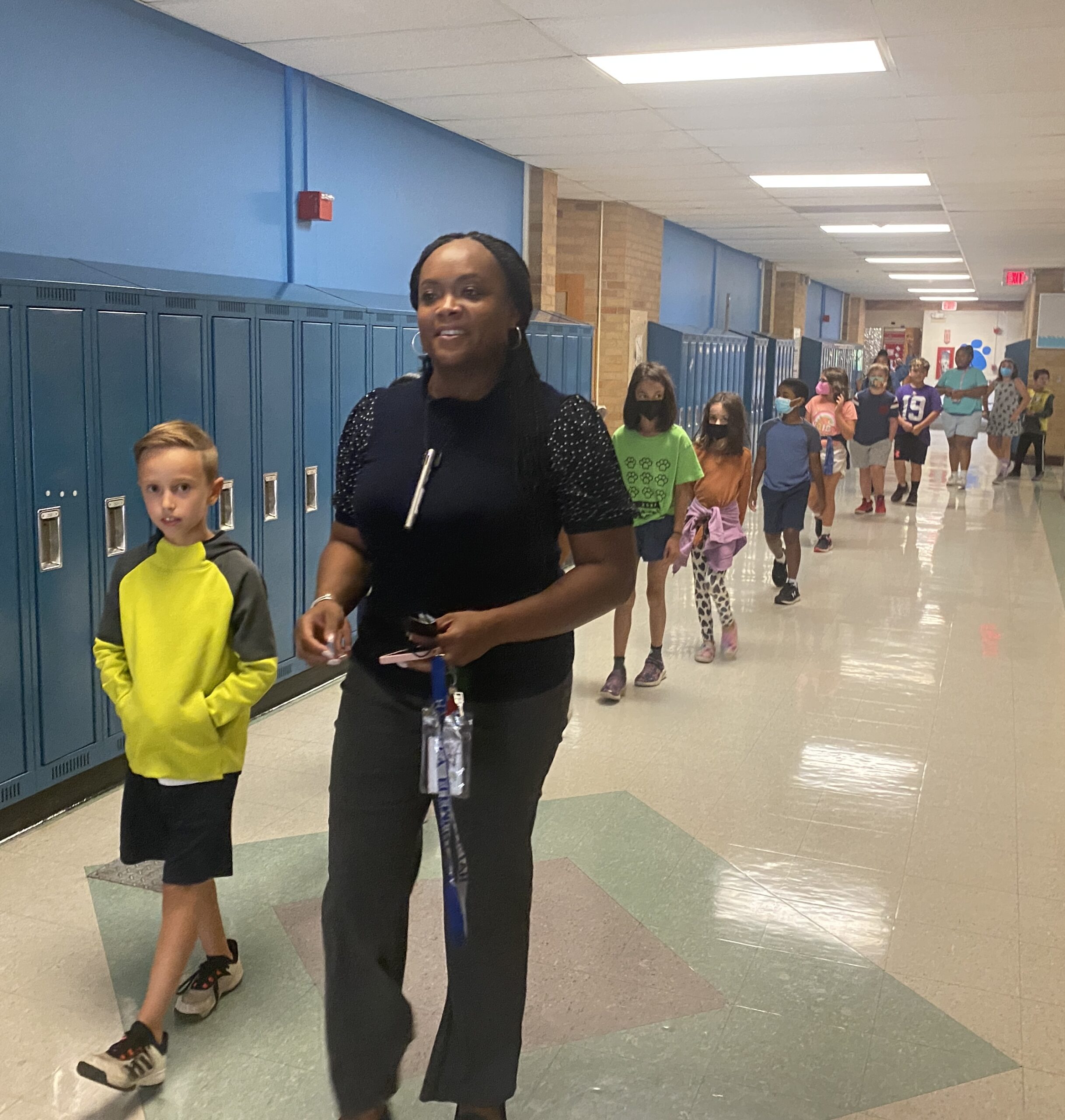 Photo of ShaRhonda Jones leading her students down the hall to art class.