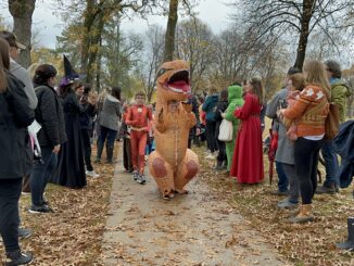 Parents watch kids in the Burns Park Halloween parade on Oct. 31, 2022