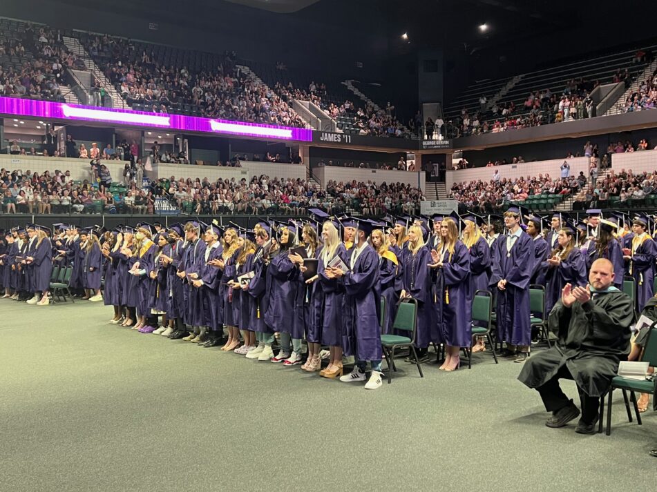 PIoneer students standing after they have turned their tassels to signify they have graduated.
