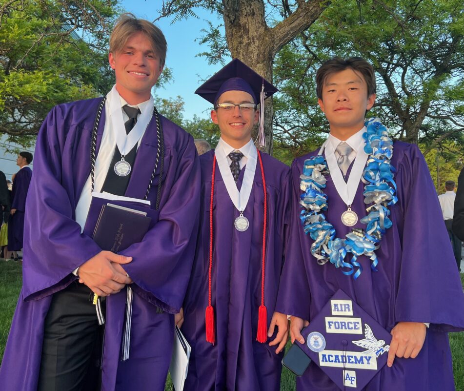 Three male Pioneer grads after the ceremony.
