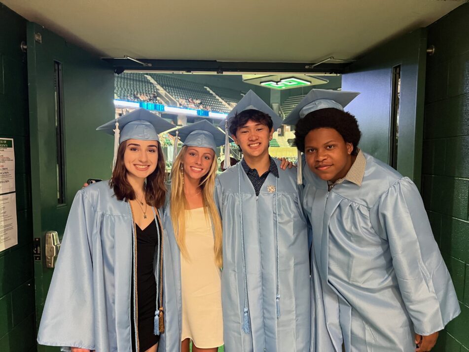 Four Skyline students in the tunnel that leads out to their commencement ceremony.