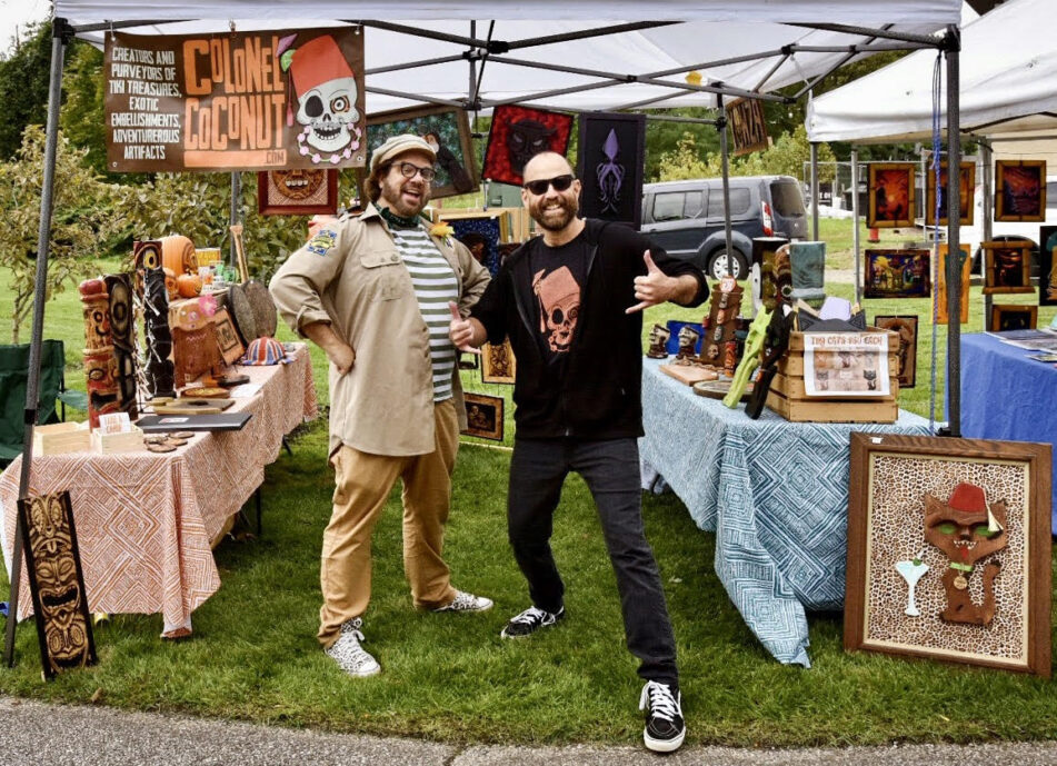 Brockie (left) with business partner Patrick Johnson vending artwork as Colonel Coconut.