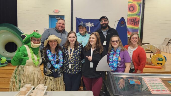 Surfs Up! Chartwells and AAPS staff pause for a photo at Lakewood Elementary in March during National Breakfast Week.