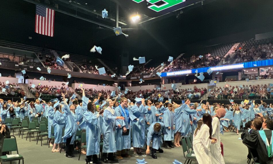 Skyline grads throw their caps into the air as they celebrate.