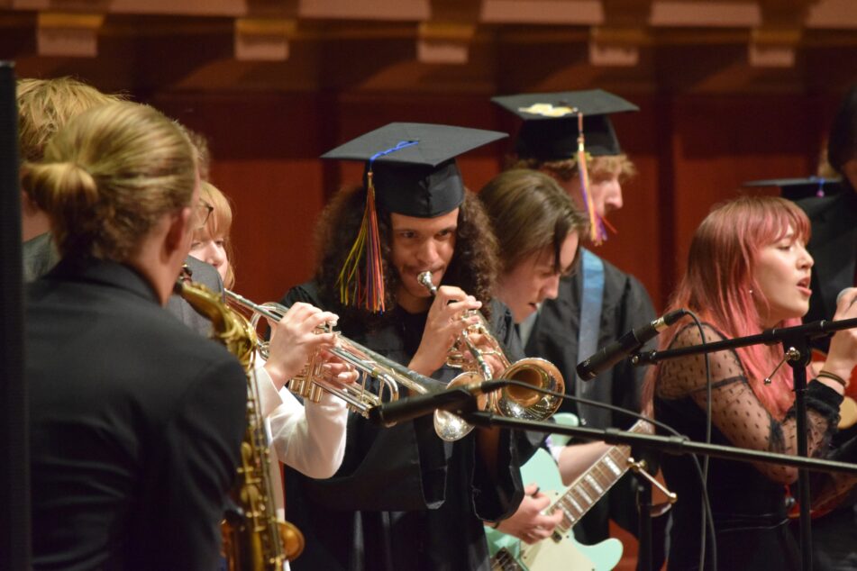 Community High Ensemble perform on stage.
