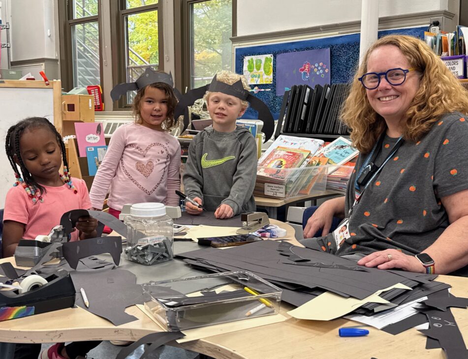 Young Angell students making bat hats for Halloween