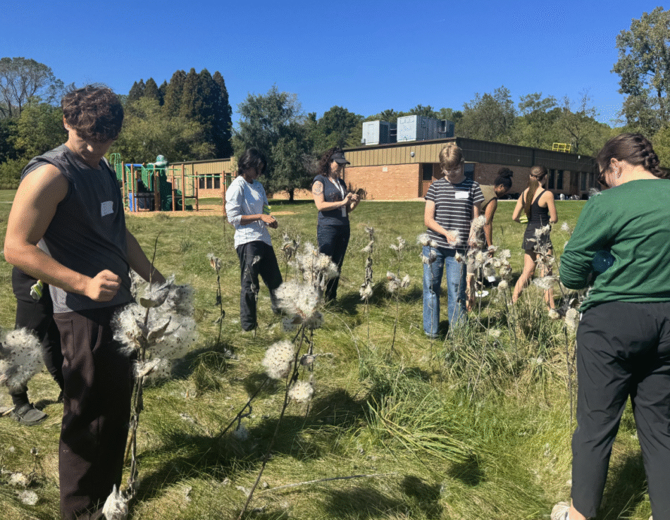 Huron volunteers in a field at the Freeman Environmental Education Center