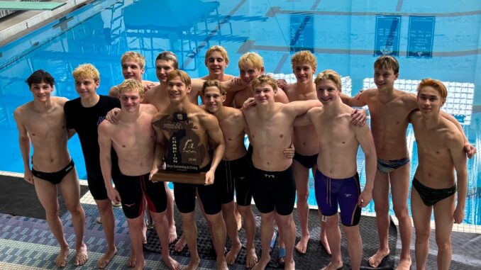 Pioneer Boys Swim and Dive team hold the state championship trophy on the pool deck.