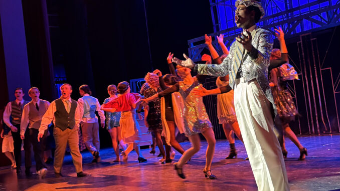 Christian Weems (Billy Flynn) performs “Razzle Dazzle” with the ensemble of Pioneer Theatre Guild’s production of Chicago: Teen Edition. (Photo credit: Quinn Strassel)
