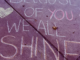 Still shot from a video honoring educators, with eh words "Because of you we all shine" written in chalk on a sidewalk