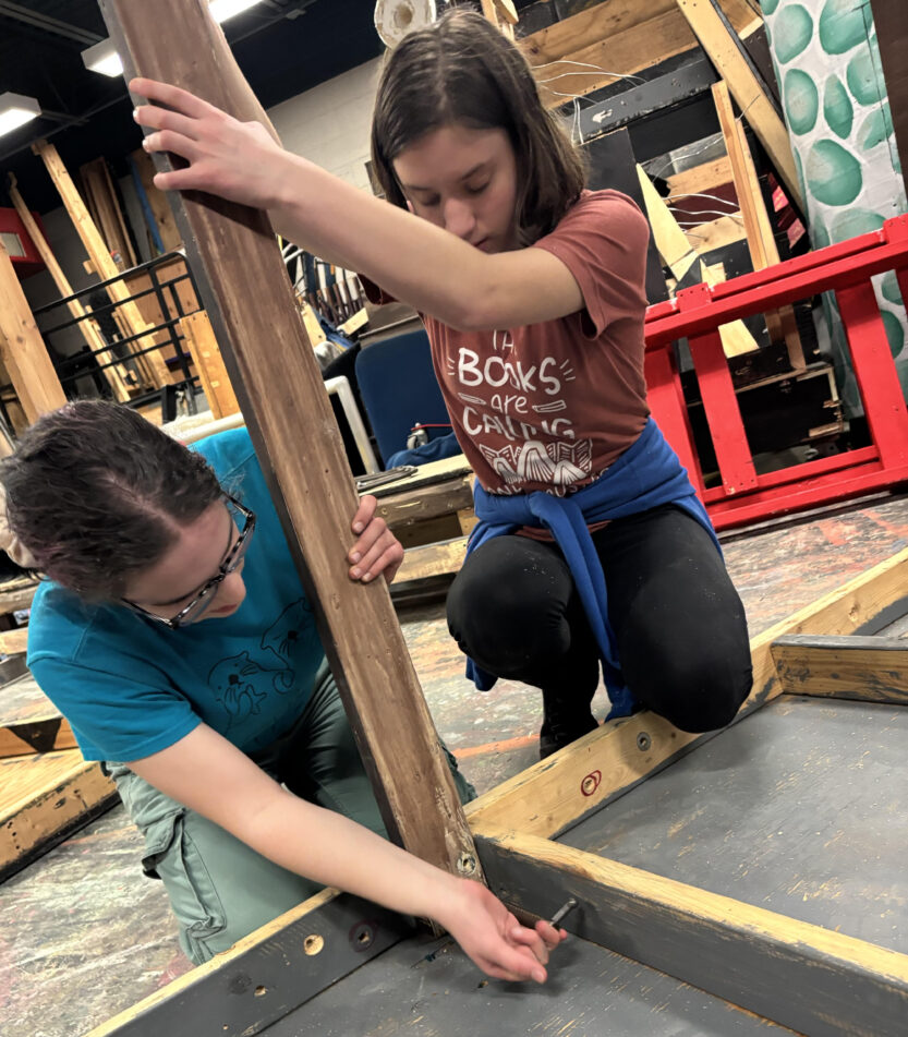 (From left) Chicago: Teen Edition set crew members Elena Bergin and Josephine Speyer assemble a platform. (photo credit: Quinn Strassel)