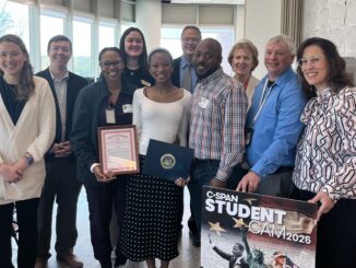 Skyline's Taylor Phillips, her parents, AAPS staff, elected officials and C SPAN representative in a Skyline classroom