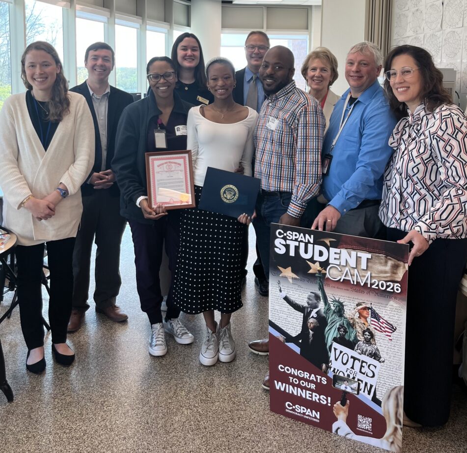 Skyline's Taylor Phillips, her parents, AAPS staff, elected officials and C SPAN representative in a Skyline classroom