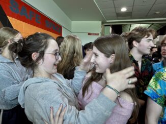 Two students embrace at the Skyline High School senior clap-out