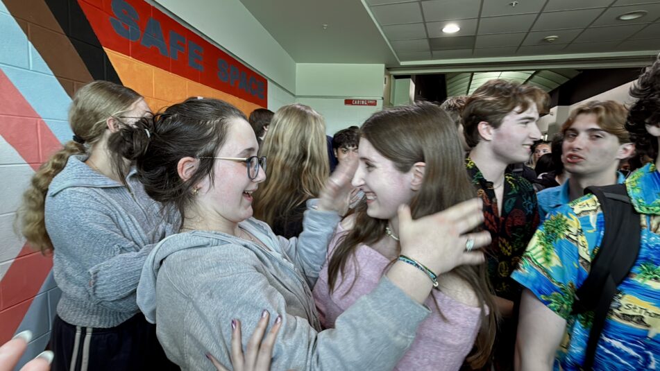 Two students embrace at the Skyline High School senior clap-out