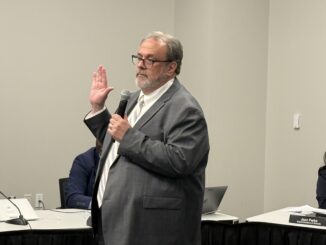 Steve Norton takes the oath of office after being picked to fill a vacancy on the Board of Education