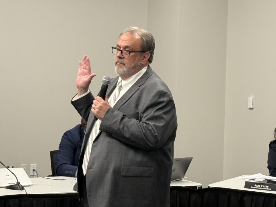 Steve Norton takes the oath of office after being picked to fill a vacancy on the Board of Education