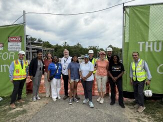 Thurston Principal Cory McElmeel, district leadership, Board of Education trustees and construction workers at the ceremonial beam raising.