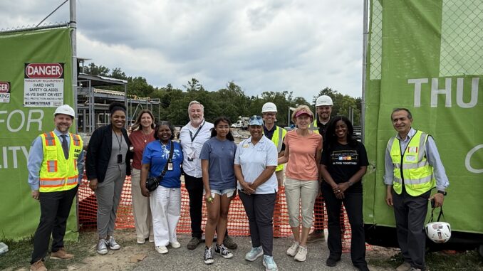 Thurston Principal Cory McElmeel, district leadership, Board of Education trustees and construction workers at the ceremonial beam raising.