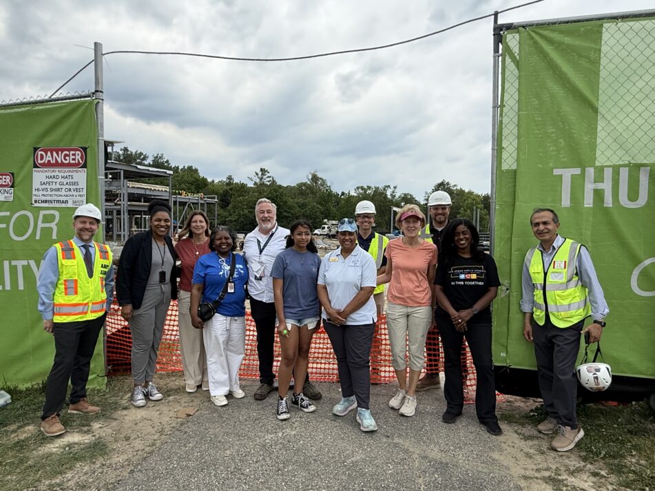 Thurston Principal Cory McElmeel, district leadership, Board of Education trustees and construction workers at the ceremonial beam raising.