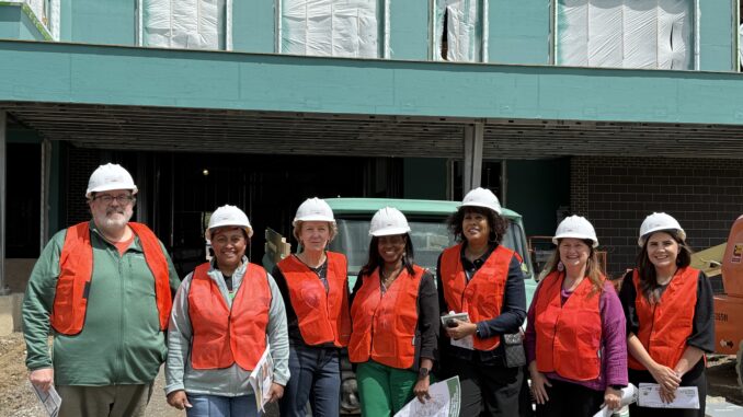 Members of the Board of Education and Superintendent Jazz Parks in front of the new Mitchell Elementary still under construction
