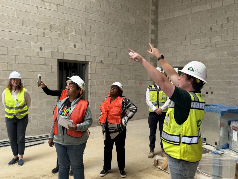 School Board trustee Susan Baskett and Assistant Superintendent, Special Education Concetta Lewis look up to see the natural light in what will become Mitchell's gym.