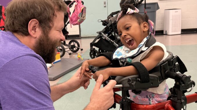 Staff and student share a laugh during AAPS' ESY program on July 8, 2026